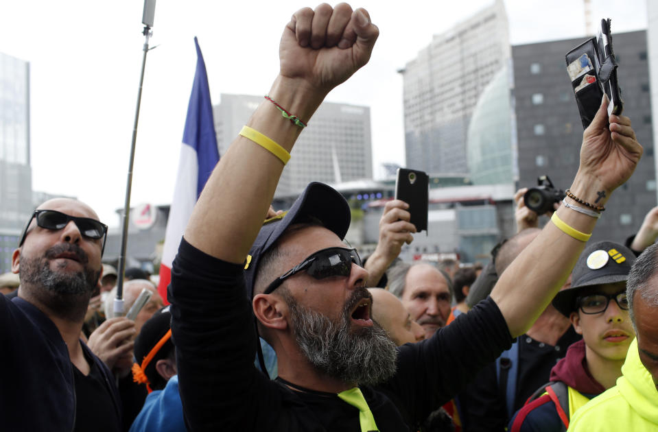 Jerome Rodriguez, center, a prominent figure of the yellow vests movement takes part in a rally in Paris, France, Saturday, April 6, 2019. Protesters from the yellow vest movement are taking to the streets of France for a 21st straight weekend, with hundreds gathered for a march across Paris, one of numerous protests around the country. (AP Photo/Rafael Yaghobzadeh)