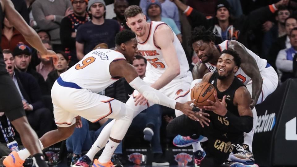 Jan 24, 2023; New York, New York, USA; Cleveland Cavaliers guard Donovan Mitchell (45) is defended by New York Knicks guard RJ Barrett (9) and forward Julius Randle (30) in the fourth quarter at Madison Square Garden.