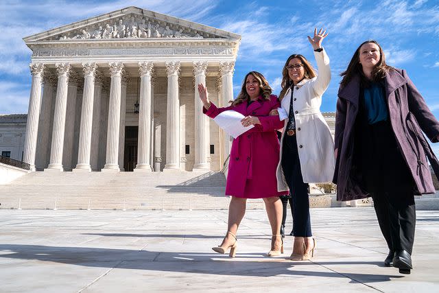 <p>Kent Nishimura / Los Angeles Times via Getty Images</p> Lorie Smith, a Christian graphic artist and website designer in Colorado (left), prepares to speak to supporters outside the Supreme Court