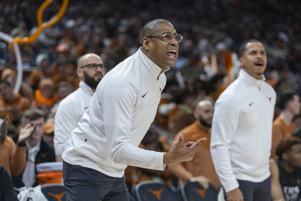 Texas interim head coach Rodney Terry, foreground, speaks to his team as they compete against Baylor during the first half of an NCAA college basketball game Monday, Jan. 30, 2023, in Austin, Texas. (AP Photo/Stephen Spillman)