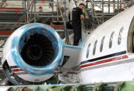 A technician works on a Bombardier Global aircraft at the company's service centre at Biggin Hill, Britain March 5, 2018. REUTERS/Peter Nicholls