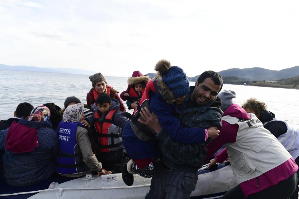 Refugees and migrants arrive with a dinghy at the village of Skala Sikaminias, on the Greek island of Lesbos, after crossing the Aegean sea from Turkey, on Friday, Feb. 28, 2020. An air strike by Syrian government forces killed scores of Turkish soldiers in northeast Syria, a Turkish official said Friday, marking the largest death toll for Turkey in a single day since it first intervened in Syria in 2016. (AP Photo/Micheal Varaklas)