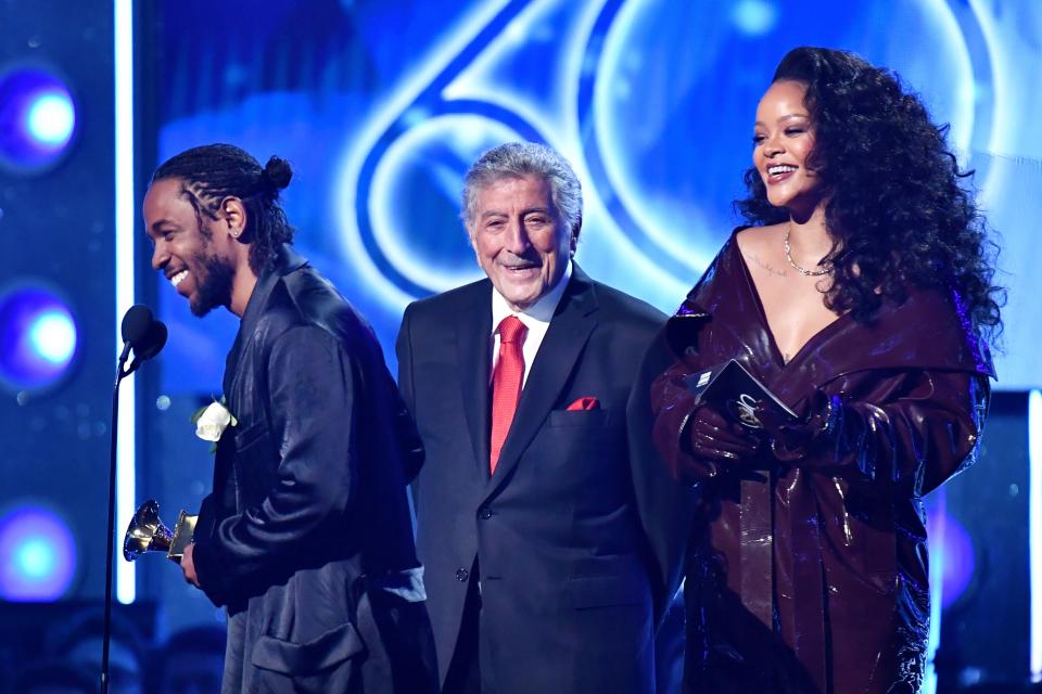 Recording artists Kendrick Lamar (L) and Rihanna (R) accept the award for Best Rap/Sung Performance from Tony Bennett