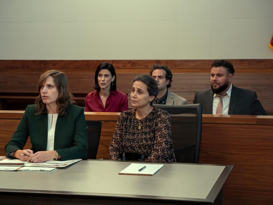 The cast of Mo sitting in court benches
