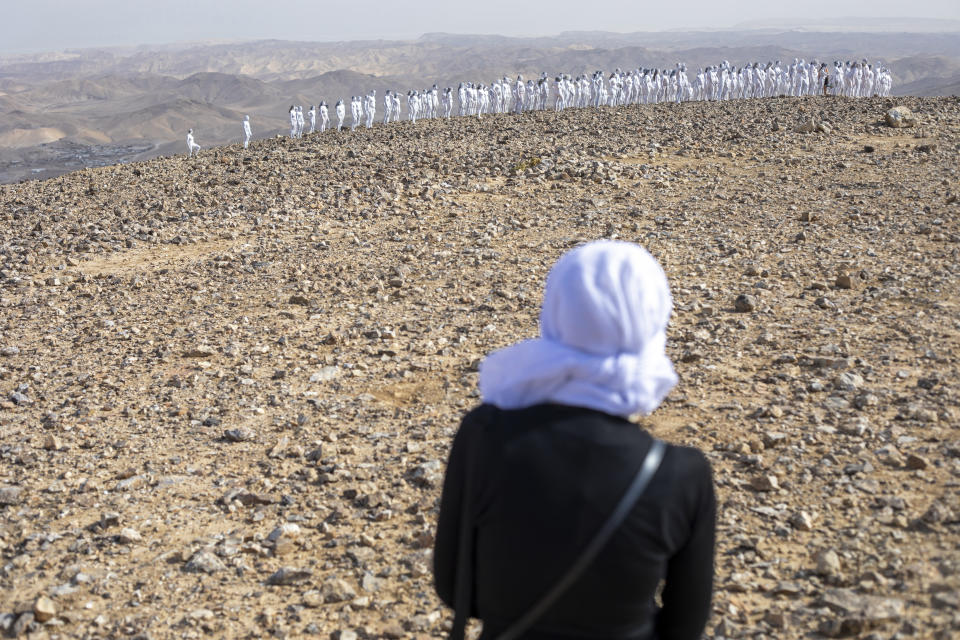 People pose nude for American artist Spencer Tunick as part of an installation in the desert near the Dead Sea, in Arad, Israel, Sunday, Oct. 17, 2021. About 300 participants took part in the nude photo installation designed to draw world attention to the importance of preserving and restoring the Dead Sea. (AP Photo/Ariel Schalit)