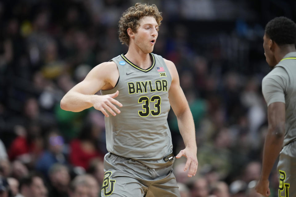 Baylor forward Caleb Lohner, left, celebrates after hitting a 3-point basket with guard Dale Bonner in the second half of a first-round college basketball game against UC Santa Barbara in the men's NCAA Tournament Friday, March 17, 2023, in Denver. (AP Photo/David Zalubowski)