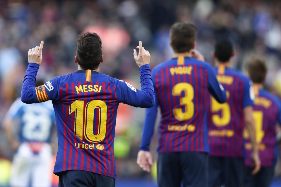 Barcelona's Lionel Messi, left, celebrates after scoring his side's second goal during a Spanish La Liga soccer match between FC Barcelona and Espanyol at the Camp Nou stadium in Barcelona, Spain, Saturday March 30, 2019. (AP Photo/Manu Fernandez)