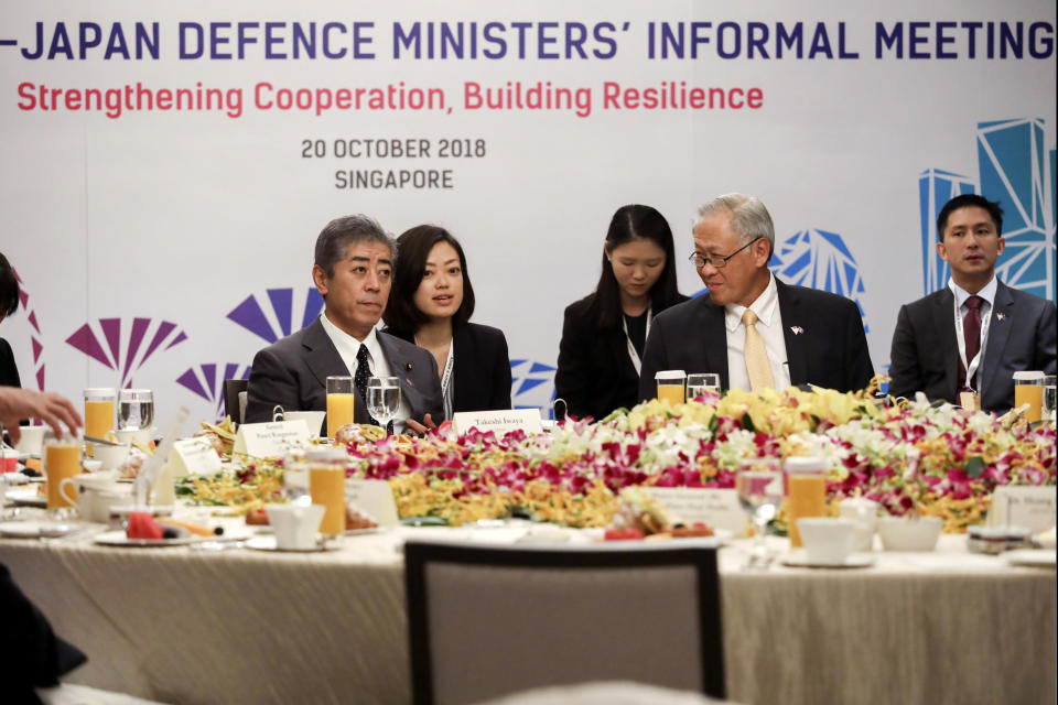 Japan's Defense Minister Takeshi Iwaya and Singapore's Defense Minister Ng Eng Hen attend the ASEAN and Japanese Defense Ministers' Informal Meeting at the 12th ASEAN Defense Ministers' Meeting in Singapore on Saturday, Oct. 20, 2018. (AP Photo/Don Wong)