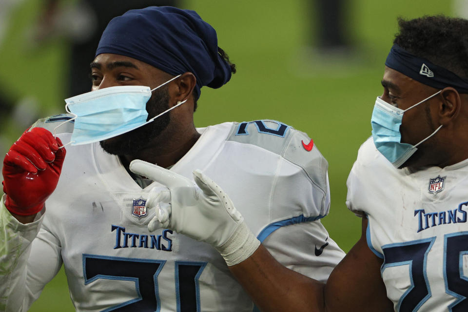 Two members of the Tennessee Titans celebrate after defeating the Baltimore Ravens on November 22, 2020. The team experienced a major outbreak in October that led the NFL to escalate precautions. (Photo by Patrick Smith/Getty Images)