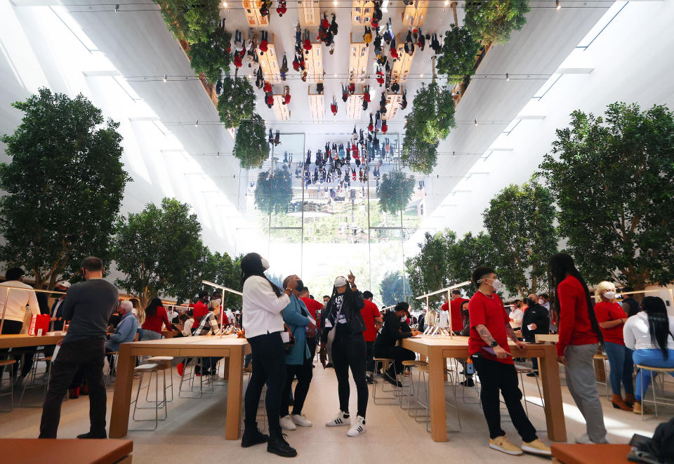 LOS ANGELES, CALIFORNIA - NOVEMBER 19: People attend the grand opening event of the new Apple store at The Grove on November 19, 2021 in Los Angeles, California. The original Apple store in The Grove was opened in 2002 but was redesigned in a new location with twice the space and opened today in time for the holiday shopping season. (Photo by Mario Tama/Getty Images)