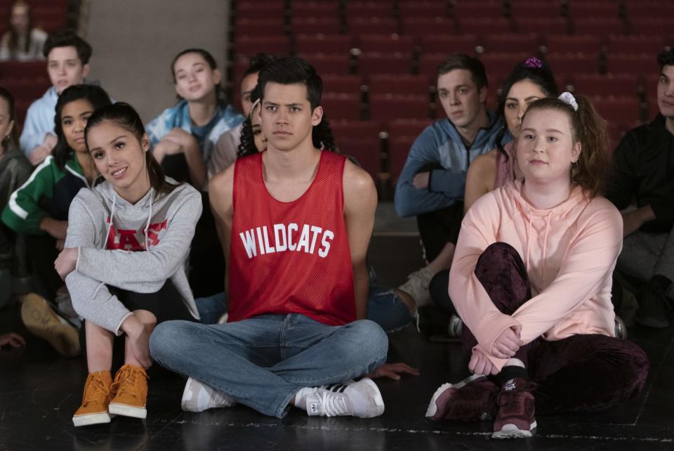 Olivia Rodrigo, Matt Cornett, and Julia Lester sit on the floor during auditions