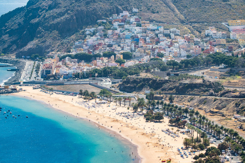 Aerial and panoramic view of San Andres village over the famous and popular exotic Playa De Las Teresitas beach, Santa Cruz de Tenerife, in Canary islands, Spain. The village is built on the foot of Anaga mountains with panoramic view and colorful houses. It is the oldest village of Canary Islands and has many names from the past like Abicor, Ibaute, Two valleys, valle de Salazar, San Andreas, San Andres de Pots etc. (Photo by Nicolas Economou/NurPhoto via Getty Images)