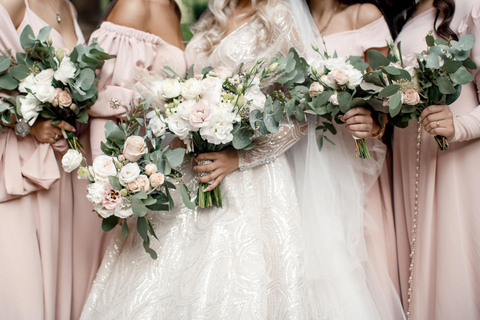 Bride and her bridesmaids holding bouquets