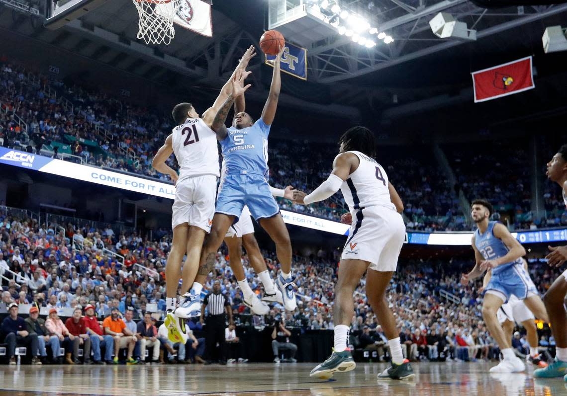 North Carolina’s Armando Bacot (5) shoots as Virginia’s Kadin Shedrick (21) defends during the first half of UNC’s game against Virginia in the quarterfinals of the ACC Men’s Basketball Tournament in Greensboro, N.C., Thursday, March 9, 2023.