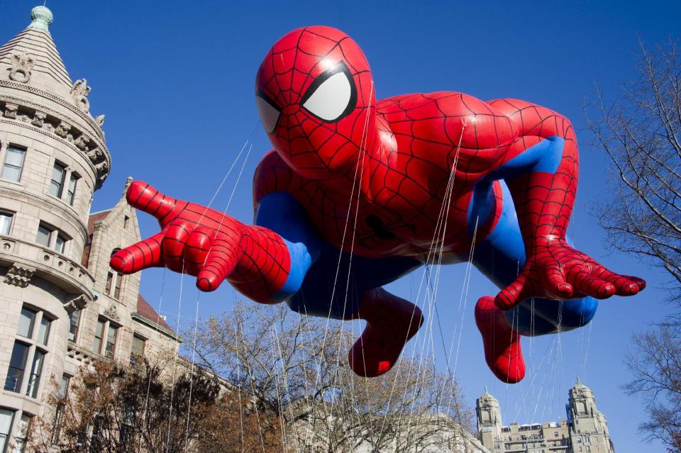 FILE - This Nov. 24, 2011 file photo shows the Spider-Man balloon during the Macy's Thanksgiving Day Parade in New York. The parade has to be a crowd-pleaser for a multigenerational crowd. More than 3 million people typically attend the event that also unfolds in front of a TV audience of 50 million. This year's parade will feature balloons include Papa Smurf and the Elf on a Shelf, while Buzz Lightyear, Sailor Mickey Mouse and the Pillsbury Doughboy keep their place in the lineup. A new version of Hello Kitty is also to be included. (AP Photo/Charles Sykes, file)