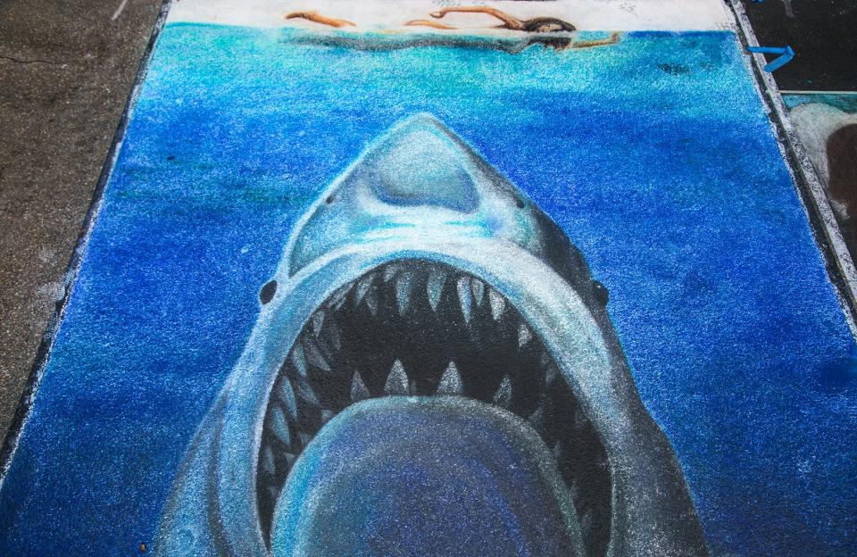 A chalk drawing of the poster for "Jaws", the 1975 film directed by Steven Spielberg and based on Peter Benchley's novel of the same name, at the 2014 Lake Worth Street Painting Festival. (Greg Lovett/The Palm Beach Post)