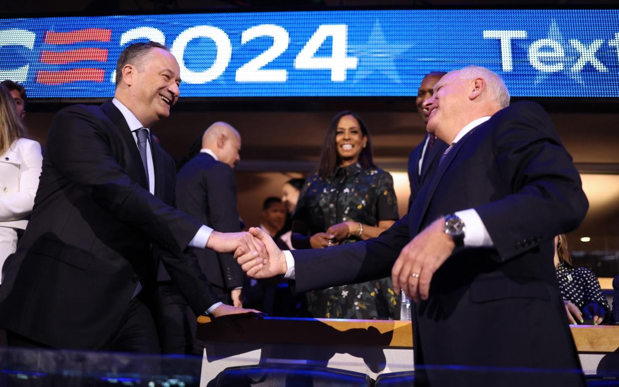 Doug Emhoff, Kamala Harris' husband and the US Second Gentleman, shakes hands with Tim Walz