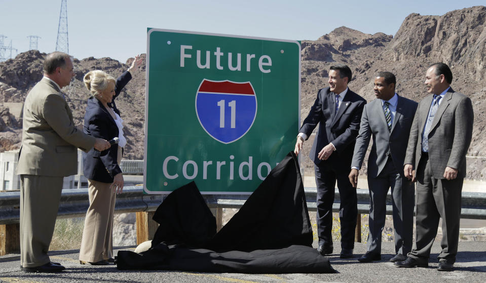 <p> From left, Arizona Department of Transportation director John Halikowski, Arizona governor Jan Brewer, Nevada governor Brian Sandoval, Steven Horsford, D-Nev., and Nevada Department of Transportation director Rudy Malfabon unveil a sign that will mark the corridor for the future Interstate 11 between Phoenix and Las Vegas, Friday, March 21, 2014, at Hoover Dam, Ariz. It was a symbolic effort meant to keep up momentum on the project, which is coming of age in an era of scarce highway funding. (AP Photo/Julie Jacobson) </p>