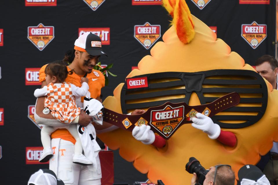 Tennessee quarterback Nico Iamaleava (8) is presented with the MVP belt by Cheez-It mascot Ched-Z during the award ceremony after the Cheez-It Citrus Bowl NCAA College football game against Iowa on Jan. 1 in Orlando, Florida.