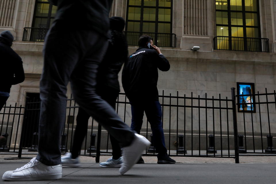 Trader Frank Masiello talks on his phone on Wall St. outside the New York Stock Exchange (NYSE) in New York, U.S., January 15, 2021. REUTERS/Brendan McDermid