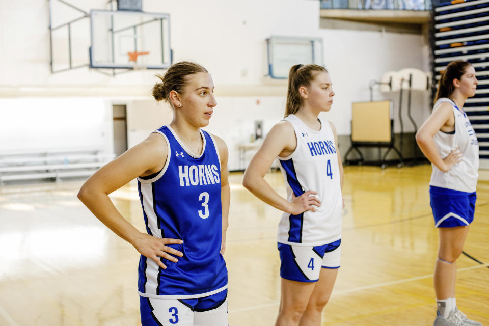 This photo provided by the University of Lethbridge shows Ukrainian nationals Vlada Hozalova (3) and Vika Kovalevska (4) on the court during basketball practice at the University of Lethbridge, in Lethbridge, Alberta, Monday, Oct. 3, 2022. Kovalevska and Hozalova have found brief sanctuary from the war in their homeland playing for the University of Lethbridge. The pair fled their Ukrainian homes and arrived in Canada in May. Kovalevska and Hozalova are friends who have played internationally for Ukraine’s under-20 women’s team. (Leslie Ohene-Adjei/University of Lethbridge via AP)