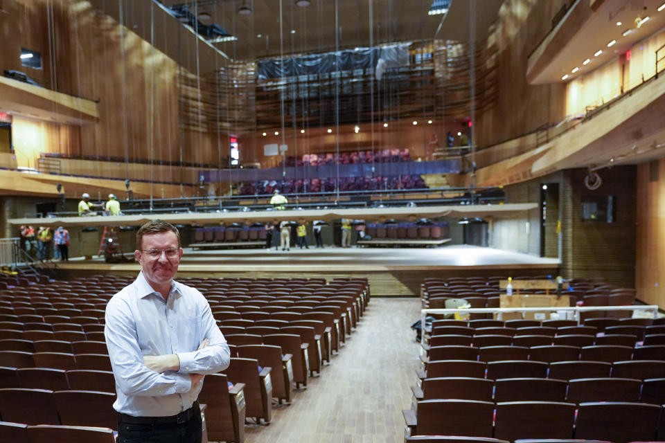 Henry Timms, President and CEO at the Lincoln Center for the Performing Arts, poses for a portrait in the newly renovated Wsu Tsai Theater at David Geffen Hall, Thursday, Aug. 25, 2022, at the Lincoln Center in New York. After a $550 million renovation that took two years, the New York Philharmonic returns to David Geffen Hall for a series of openings beginning with a Thursday night ribbon-cutting, a Friday performance for construction workers and Saturday afternoon and evening community concerts. (AP Photo/Mary Altaffer)