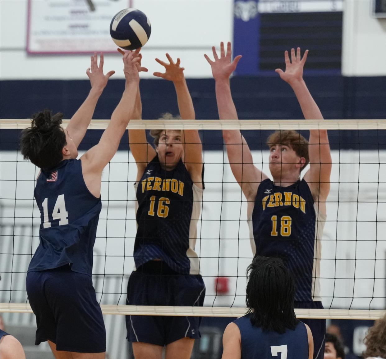 Randolph, NJ May 20, 2023 -- Hunter Kasper of Randolph and Pearse Esposito and Ben Jurewicz of Vernon in the first game. Randolph won the Northwest New Jersey Athletic Conference Volleyball Final with a 25-23 and 25-18 win in a game played at Randolph.