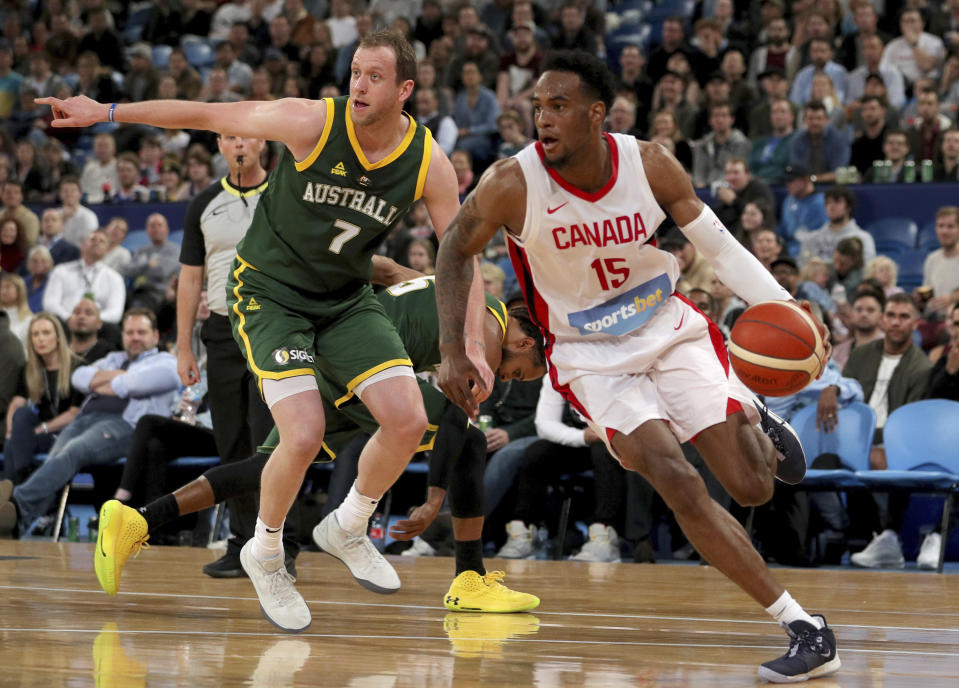 Canada's Oshae Brissett, right, drives past Joe Ingles, of Australia, during an exhibition basketball game in Perth, Australia, Friday, Aug. 16, 2019. (Richard Wainwright/AAP Image via AP)