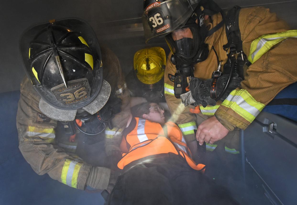 Oxygen masks like the ones Jacksonville firefighters in this 2016 photo are using to practice rescuing passengers from a smoky train wreck are designed to fit tight against firefighters' faces. A federal judge this month ruled the law leaves "no mechanism" for adjusting grooming standards that require firefighters to be cleanshaven for the tightest possible fit, even though doing so can cause many Black firefighters to experience ingrown hairs, skin irritation and scarring.