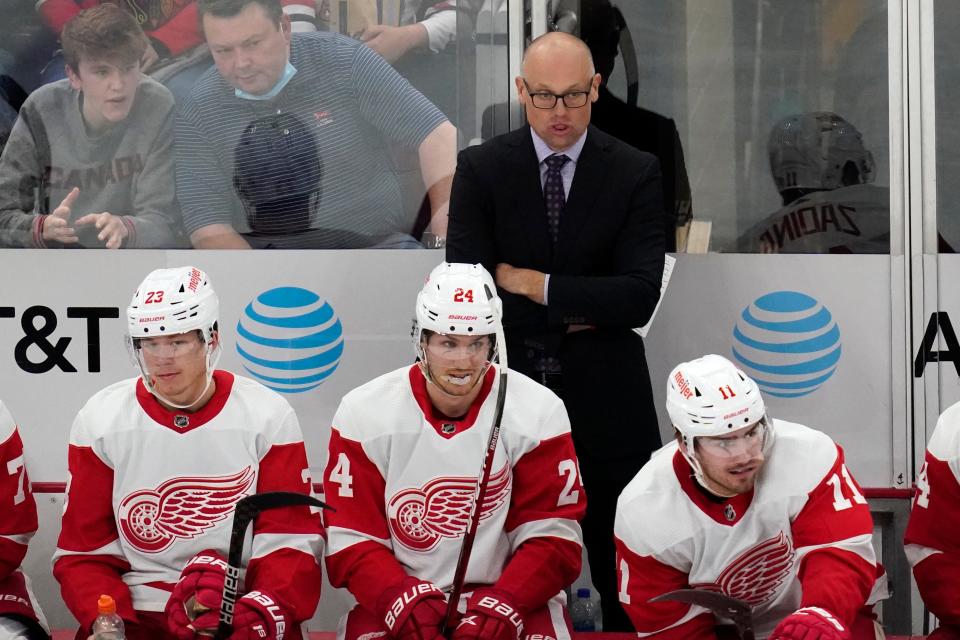 Red Wings coach Jeff Blashill, top center, watches his team during the third period of the Wings' 6-3 win on Sunday, Oct. 24, 2021, in Chicago.