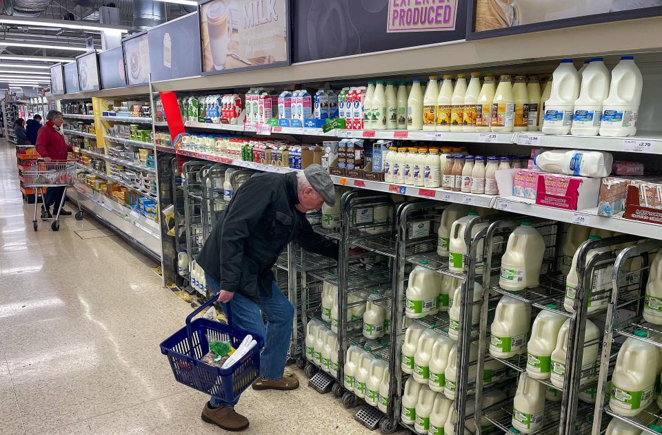 A customer shops for milk inside a Sainsbury's supermarket in east London on February 20, 2023. - British retail sales rebounded surprisingly in January on falling fuel costs and discounting by online and physical stores, official data showed Friday. At the same time, food sales dropped 0.5 percent, the ONS said, following large price rises over the past year. (Photo by Daniel LEAL / AFP) (Photo by DANIEL LEAL/AFP via Getty Images)