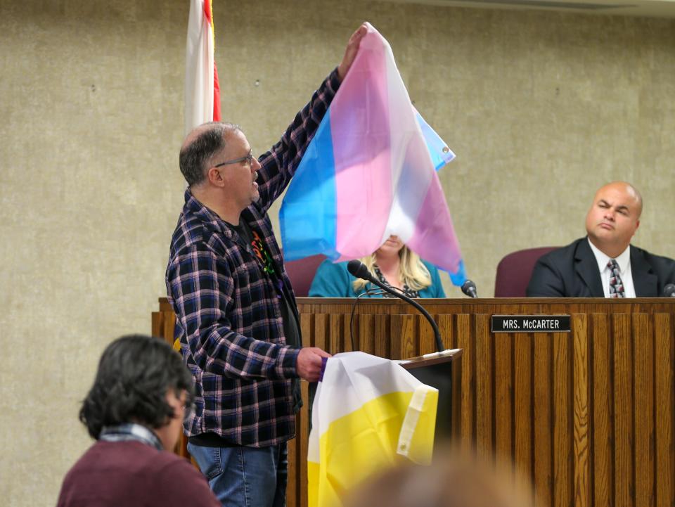 Lyle Janney, a concerned parent, showcases the Transgender pride flag and Non-Binary pride flags to members of the Lafayette School Corporation school board at the Lafayette School Corporation's first meeting of the 2023 year, on Jan. 9, 2023, in Lafayette, Ind.
