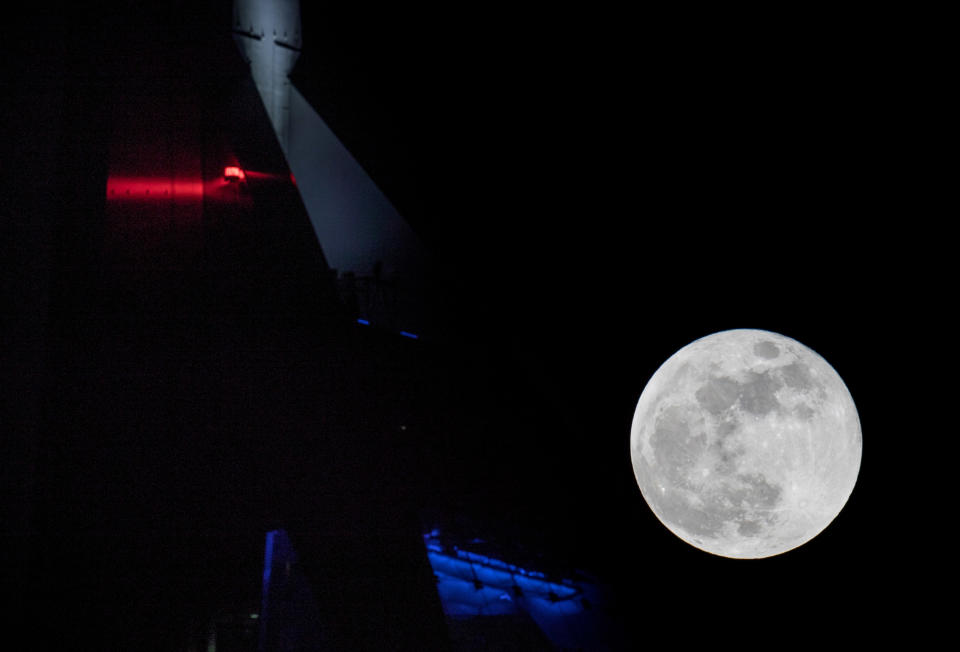 PORTSMOUTH, UNITED KINGDOM - JANUARY 31:  A Super Blue Blood Moon rises above the Spinnaker Tower in Portsmouth on January 31, 2018 in Portsmouth, United Kingdom. A Super Blue Blood Moon is the result of three lunar phenomena happening all at once: not only is it the second full moon in January, but the moon will also be close to its nearest point to Earth on its orbit, and be totally eclipsed by the Earth's shadow. The last time these events coincided was in 1866, 152 years ago  (Photo by Matt Cardy/Getty Images)