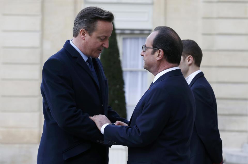 French President Francois Hollande welcomes Britain's Prime Minister David Cameron at the Elysee Palace before attending a solidarity march in the streets of Paris