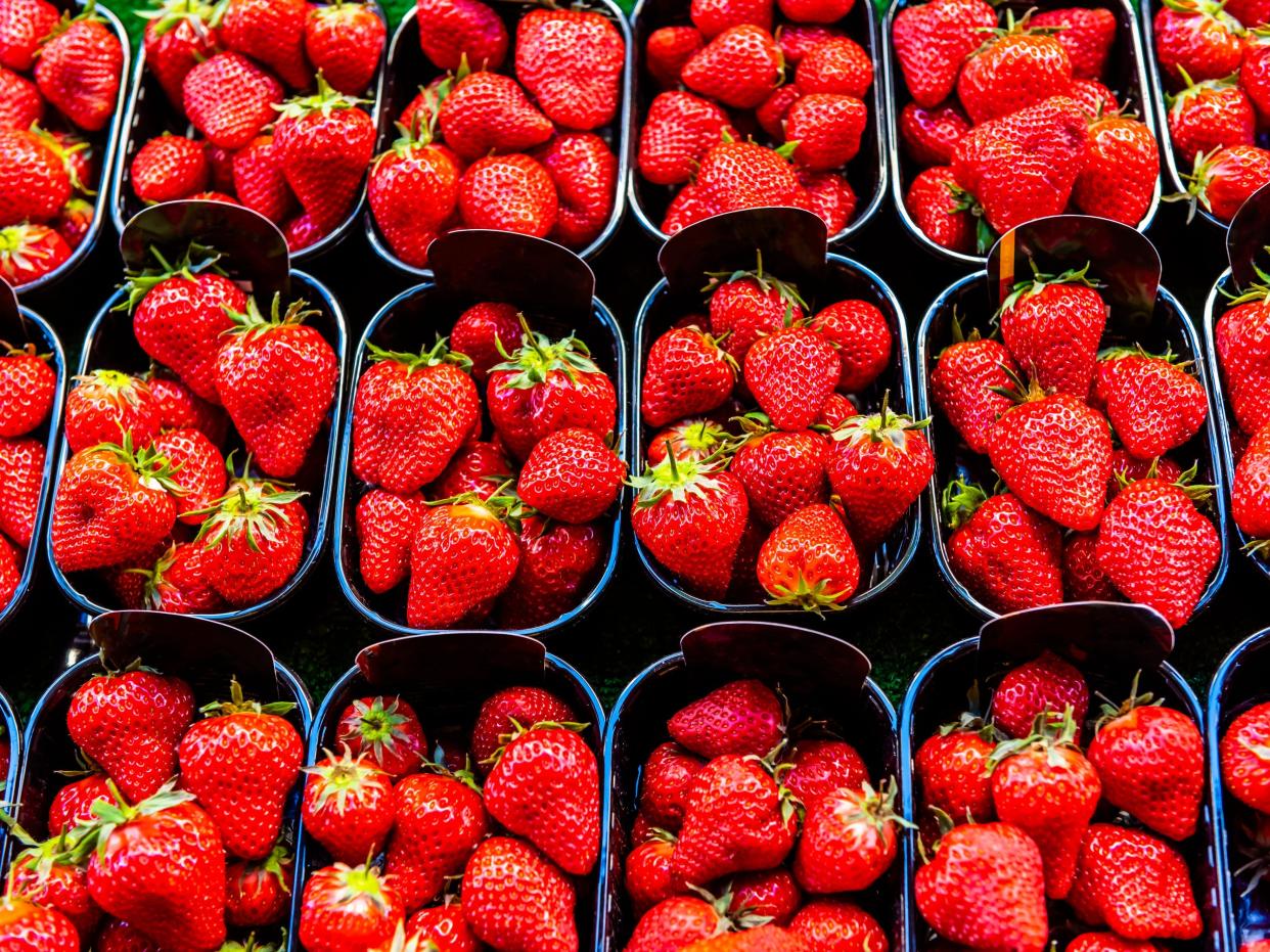 Strawberries for sale at Rue Cler street market, Paris, France.