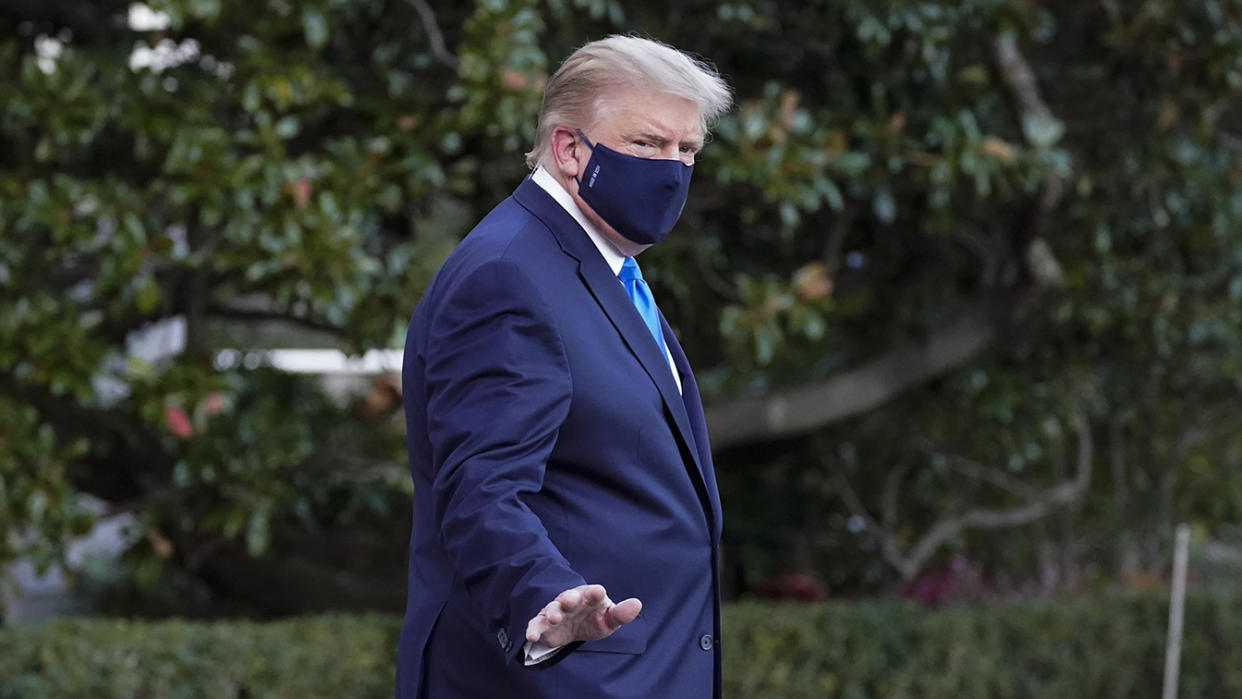 President Donald Trump waves to members of the media as he leaves the White House to go to Walter Reed National Military Medical Center after he tested positive for COVID-19, Friday, Oct. 2, 2020, in Washington. (AP Photo/Alex Brandon)