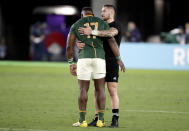 New Zealand's TJ Perenara embraces South Africa's Tendai Mtawarira following their Rugby World Cup Pool B game at International Stadium between New Zealand and South Africa in Yokohama, Japan, Saturday, Sept. 21, 2019. New Zealand defeated South Africa 23-13. (AP Photo/Jae Hong)