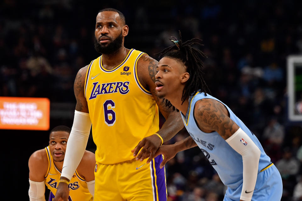 Ja Morant (R) and Memphis have won 11 consecutive games while LeBron James and the Lakers are five games under .500. (Photo by Justin Ford/Getty Images)