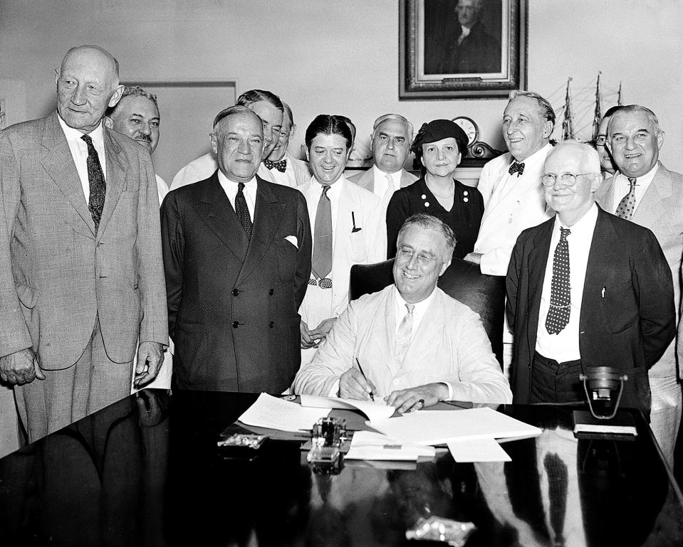 In this Aug. 14, 1935, photo President Franklin Roosevelt signs the Social Security bill in Washington. The first old-age monthly benefit check was paid in 1940, years after Roosevelt signed the act in 1935.