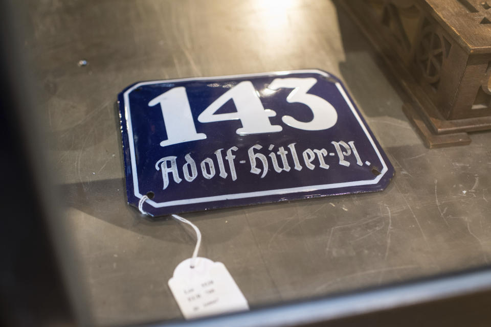 In this Wednesday, Nov. 20, 2019, photo, a street sign for '143 Adolf Hitler Place' is displayed for an auction at the 'Hermann Historica' auction house in Grasbrunn near Munich, Germany. A Geneva businessman says he has purchased Adolf Hitler's top hat and other Nazi memorabilia to keep them out of the hands of neo-Nazis and will donate them to a Jewish group. (Matthias Balk/dpa via AP)