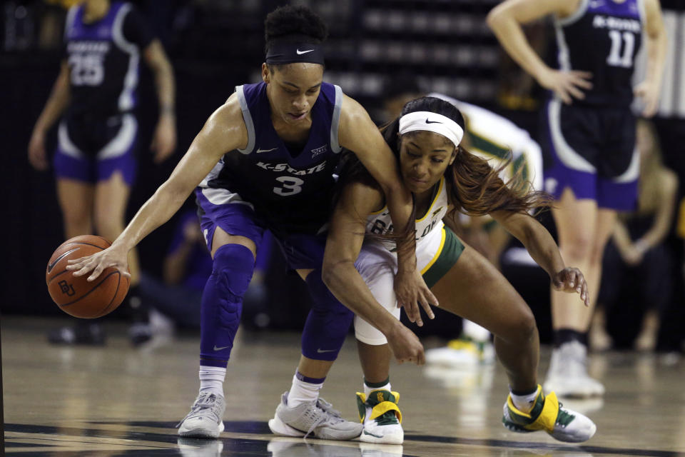 Kansas State guard Angela Harris, left, fights off Baylor guard Te'a Cooper, right, while setting up a play in the second half of an NCAA college basketball game, Saturday, Feb. 29, 2020, in Waco, Texas. (AP Photo/Rod Aydelotte)