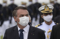 Brazilian President Jair Bolsonaro attends a graduation ceremony at the Naval Academy, in Rio de Janeiro, Brazil, Saturday, June 19, 2021, amid the COVID-19 pandemic. People gathered across the country Saturday, to protest Bolsonaro's handling of the pandemic and economic policies protesters say harm the interests of the poor and working class. (AP Photo/Silvia Izquierdo)