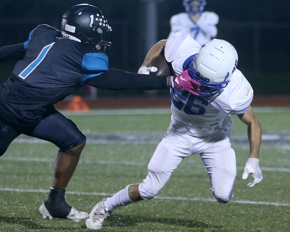 Plymouth South's Gio Lynch-Ruberio grabs the facemark of Scituate’s Charlie Hartwell for the penalty during third quarter action of their game at Plymouth South High on Friday, Oct. 14, 2023. Scituate would go on to win 48-21.