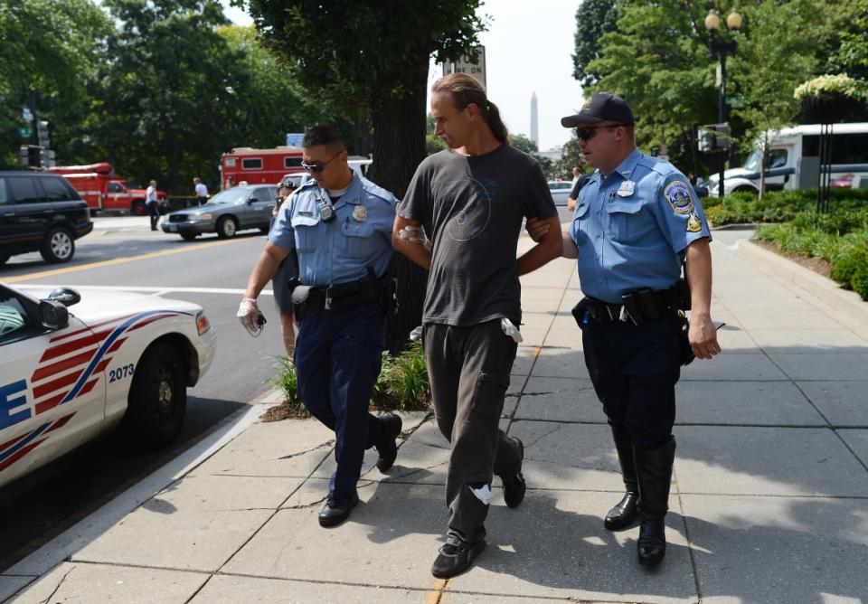 <div class="inline-image__caption"><p>Police detain David Bronner after cutting open a cage he was protesting from inside on a street near the White House in Washington, DC, on June 11, 2012. </p></div> <div class="inline-image__credit">JEWEL SAMAD/AFP/Getty</div>