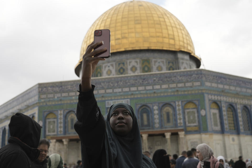 A Muslim woman takes a selfie at Friday prayers at the Dome of the Rock Mosque in the Al-Aqsa Mosque compound in the Old City of Jerusalem, Friday, Feb. 24, 2023. (AP Photo/Mahmoud Illean)