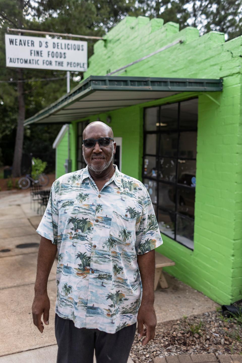 FILE - Dexter Weaver, owner of Weaver D's Delicious Fine Foods, stands in front of his restaurant on Wednesday, August 25, 2021. An Athens staple, "Automatic for the People" is the restaurant's slogan, which REM famously used for their album title.