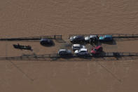 Cars sit on a submerged road in an area flooded by heavy rain in Porto Alegre, Rio Grande do Sul state, Brazil, Wednesday, May 8, 2024. (AP Photo/Andre Penner)