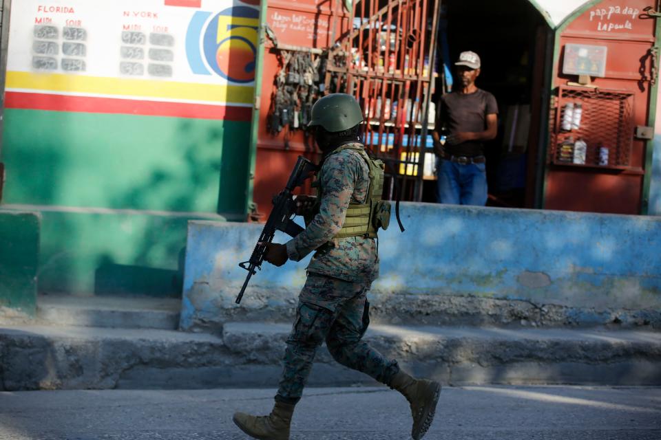 A soldier patrols the outskirts of the international airport in Port-au-Prince, Haiti, Monday, March 4, 2024. Gang members exchanged gunfire with police and soldiers around the airport in the latest of a series of attacks on government sites that includes a mass escape from the country's two biggest prisons. (AP Photo/Odelyn Joseph)