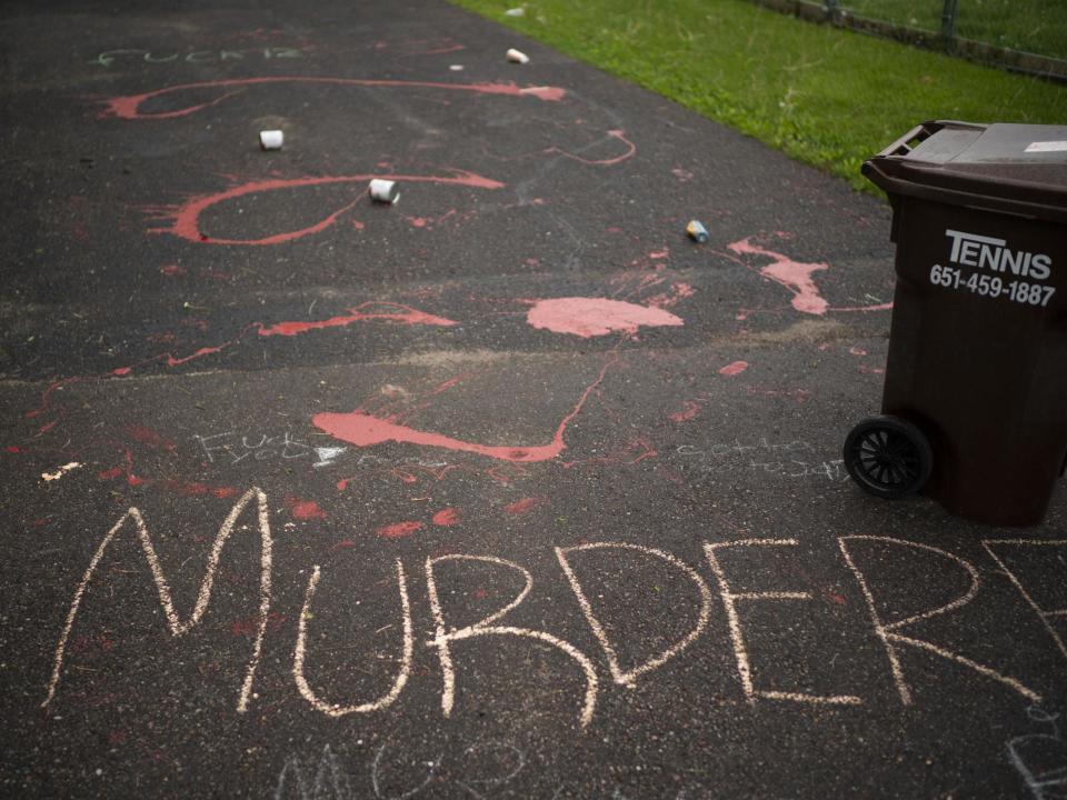 Splattered paint and chalk writing are on the driveway of the home of fired Minneapolis police Officer Derek Chauvin in Oakdale, Minn., Wednesday, May 27, 2020. The mayor of Minneapolis called Wednesday for criminal charges against Chauvin, the white police officer seen on video kneeling against the neck of Floyd George, a handcuffed black man who complained that he could not breathe and died in police custody. (Jeff Wheeler/Star Tribune via AP): Associated Press