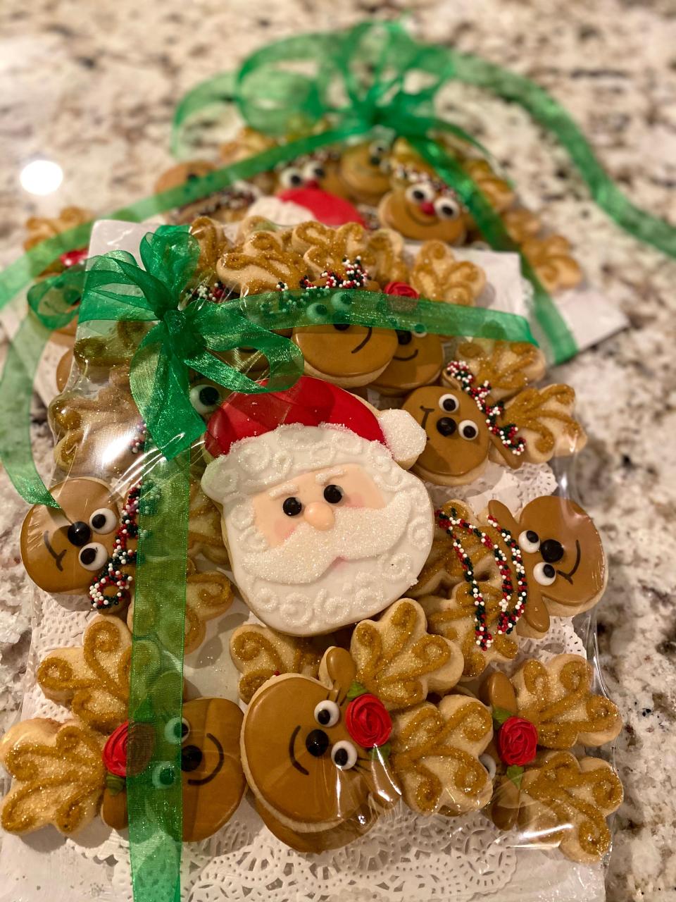 An assortment of Christmas cookies, featuring Santa and his reindeer, from Jane Dough's Sweets.